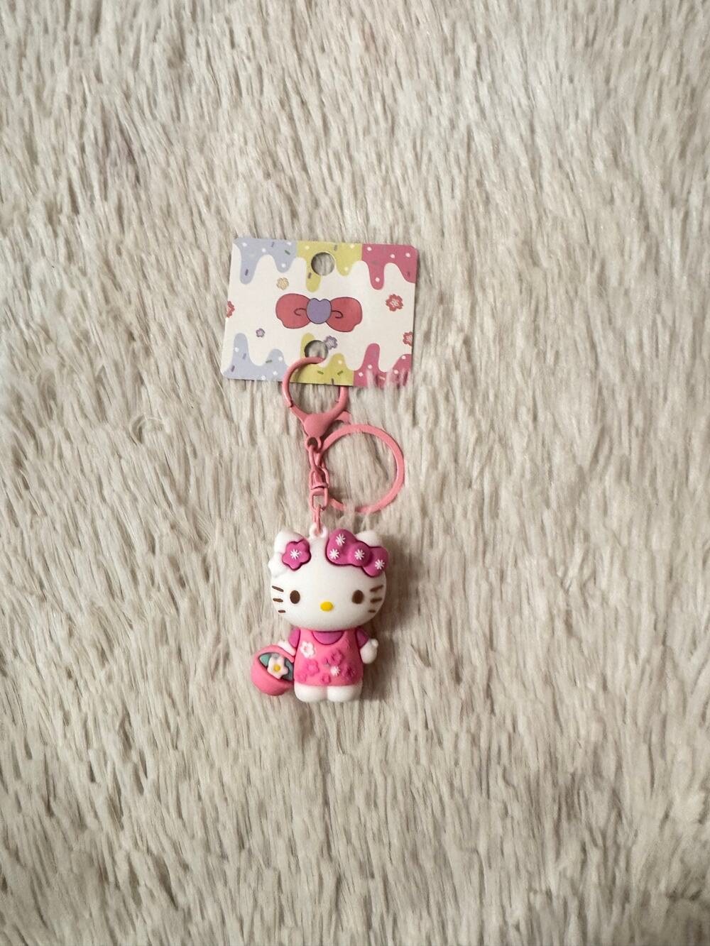 Hello Kitty keychain with pink floral dress and bow and basket of flowers